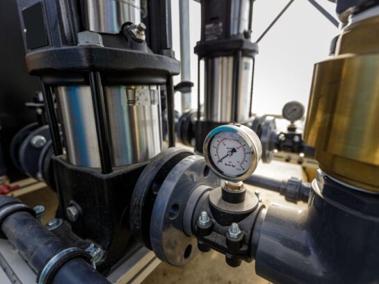 Close up of water pressure sensor or manometer with pipes and va